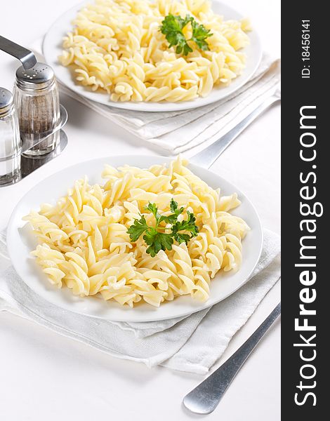 Two plates of pasta with parsley