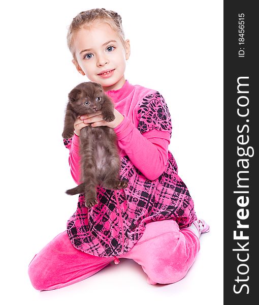 A smiling girl is playing with a kitten. isolated on a white background