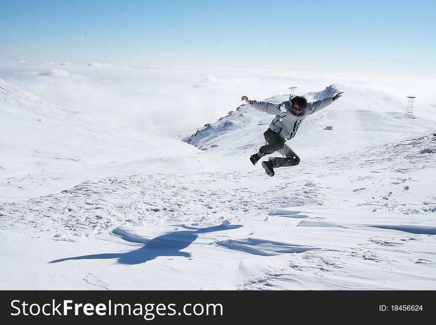 Young Man Jumping In The Snow For Fun