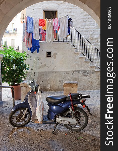 Retro blue scooter outside an Italian home. Retro blue scooter outside an Italian home