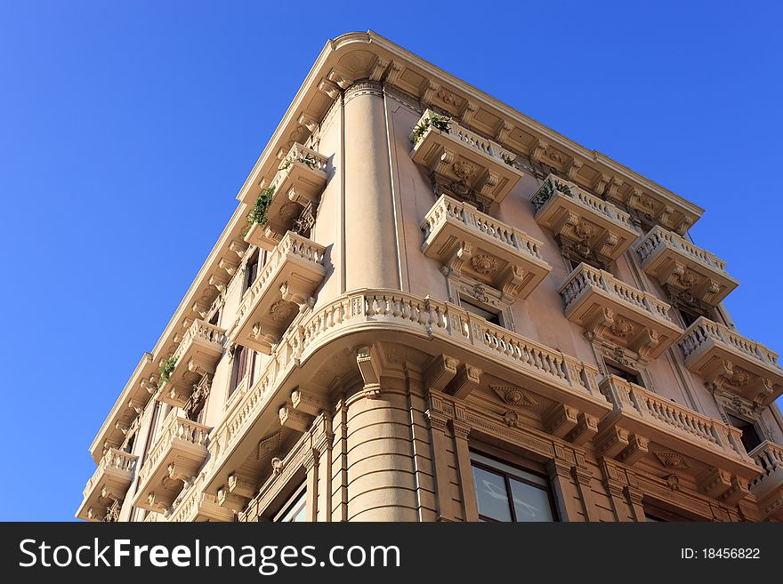 Traditional beige painted Italien apartments with ornate balconies. Traditional beige painted Italien apartments with ornate balconies