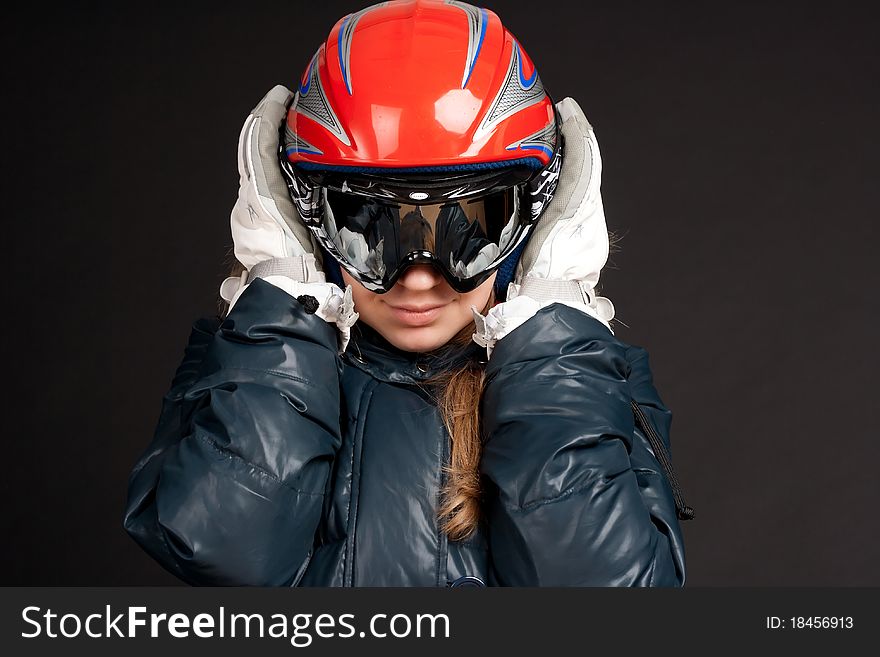A girl in a ski helmet and goggles. A girl in a ski helmet and goggles