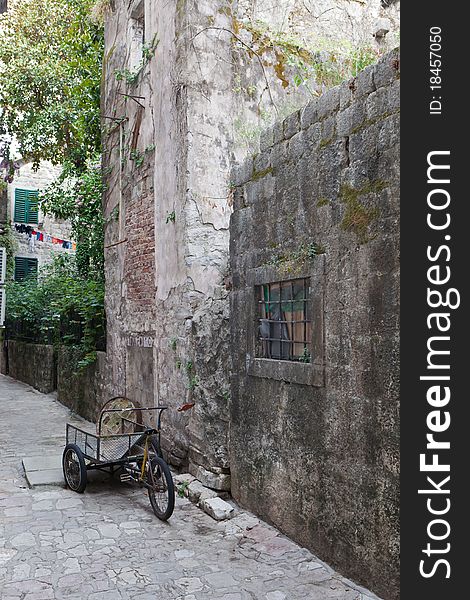 Abandoned delivery bike in old stone street