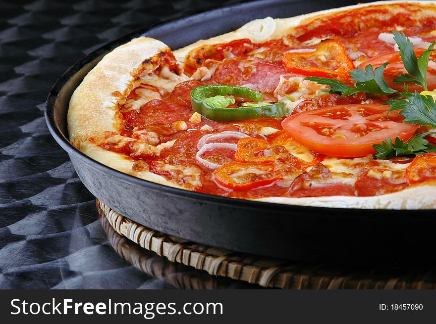 Appetizing italian pizza with tomatoes, persley, onion on steel background. Appetizing italian pizza with tomatoes, persley, onion on steel background