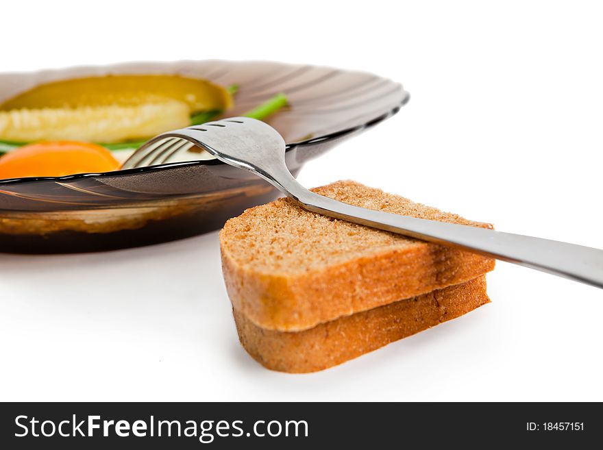 One fried eggs with slices of wholegrain toast isolated on a white background