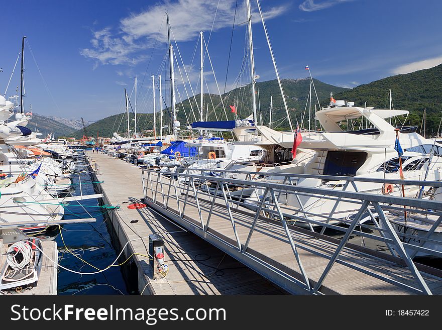 Luxury yachts at dock against a floating jetty in Montenegro. Luxury yachts at dock against a floating jetty in Montenegro