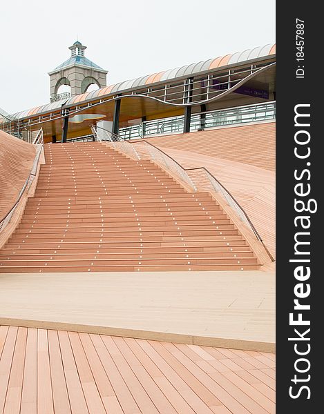 A portrait of outdoor wooden flooring and staircase. A portrait of outdoor wooden flooring and staircase