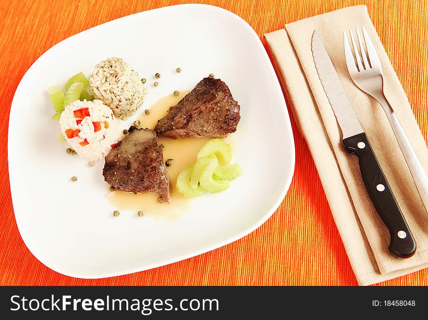 Still life view og gourmet beef steak with rice and celery on laid table surface