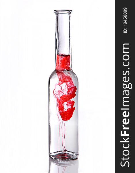 Red poison drink in bottle on white background