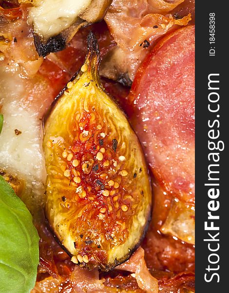 Delicious fig, mozzarella and ham pizza, closeup details