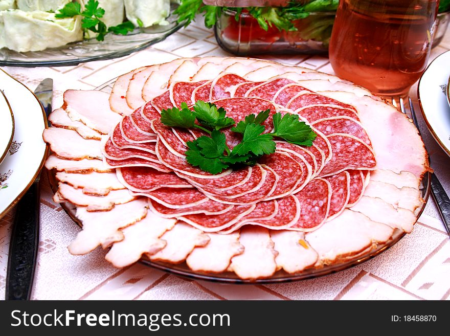 Salami slices on the table with pork