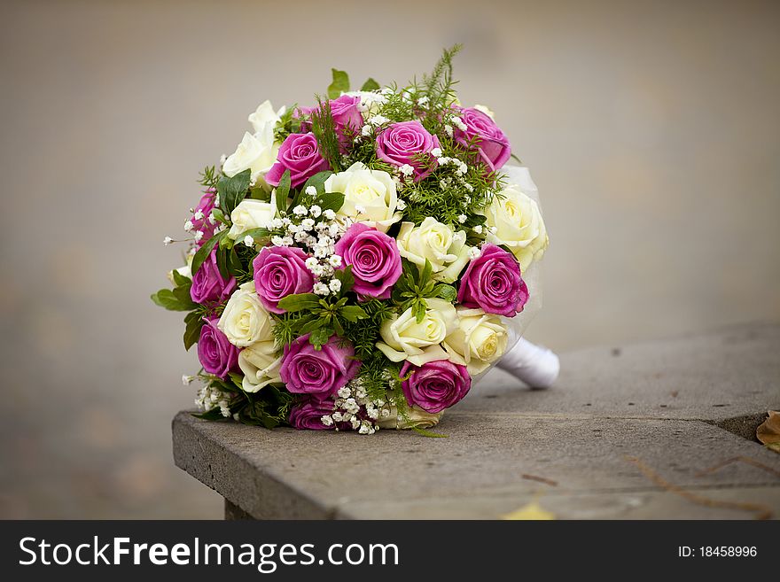 The beautiful wedding bouquet of the bride from roses with the design decision the lonely lies on the nature. The beautiful wedding bouquet of the bride from roses with the design decision the lonely lies on the nature