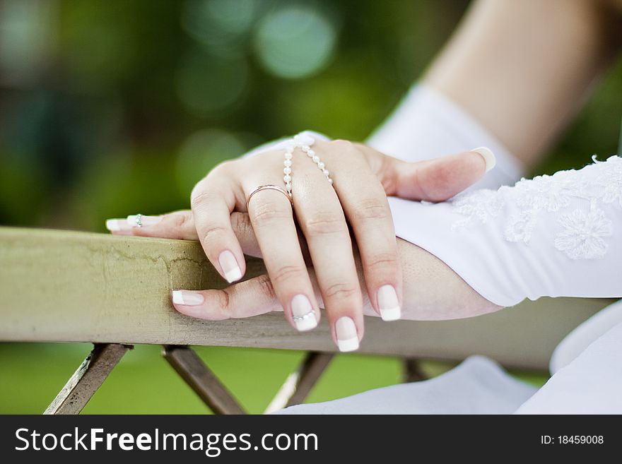 Palms of the bride are beautifully crossed and the wedding ring is visible