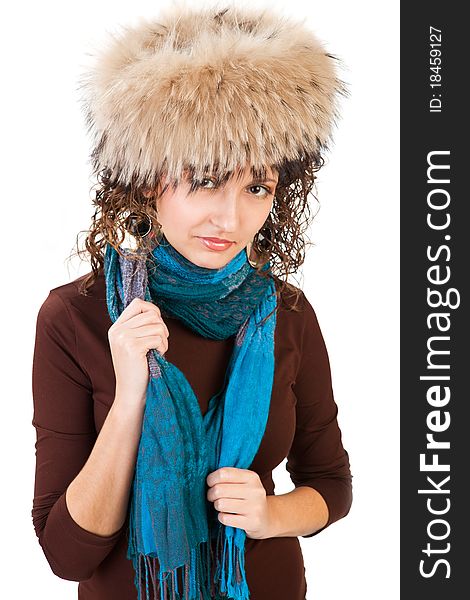 Portrait of a pretty girl in a fur hat isolated on white background