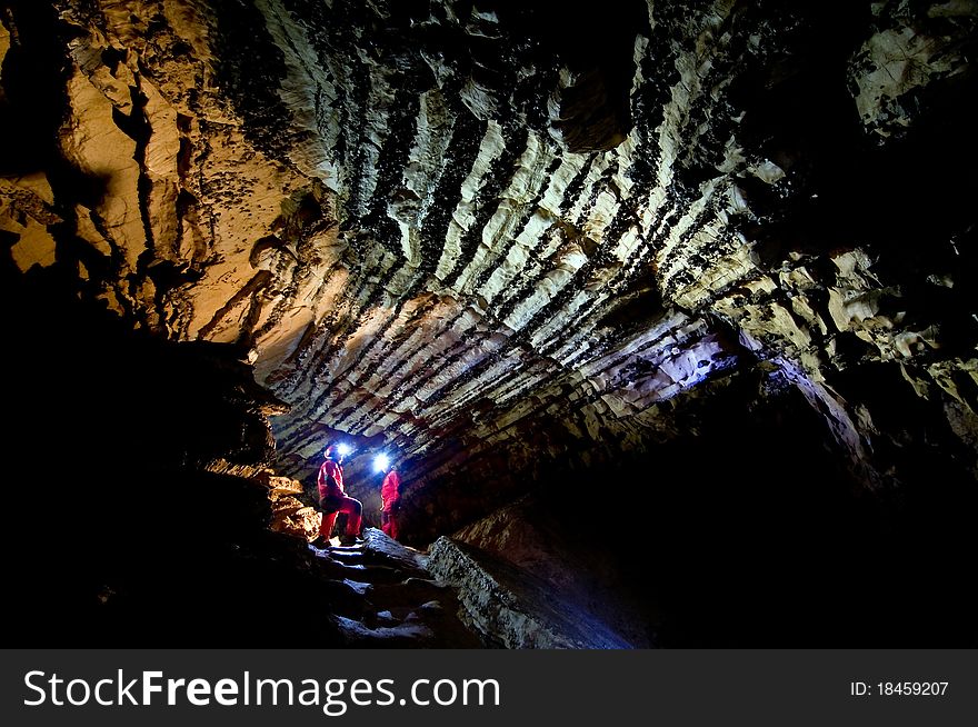 Speleologists exploring the Comarnic cave. Banatului Mountains, Romania