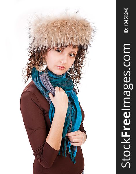 Portrait of a pretty girl in a fur hat isolated on white background