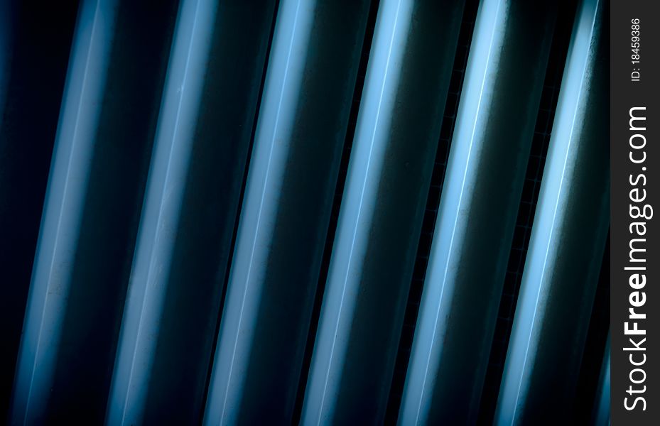 Metal bars with blue light on them. Metal bars with blue light on them