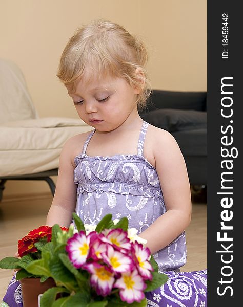 Girl Sits On The Floor And Plays With Flower