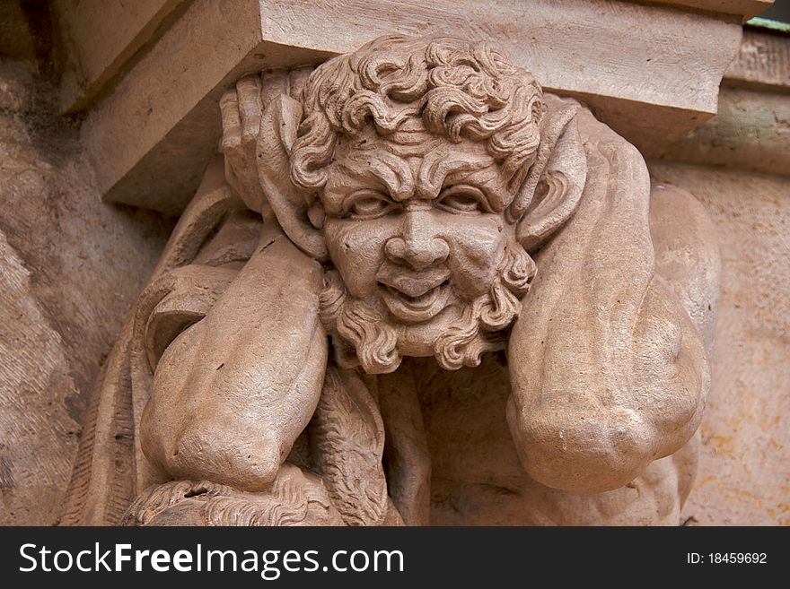 Close-up of a satyr supporting a column of the Wallpavillion of the Zwinger Palace, Dresden. Close-up of a satyr supporting a column of the Wallpavillion of the Zwinger Palace, Dresden