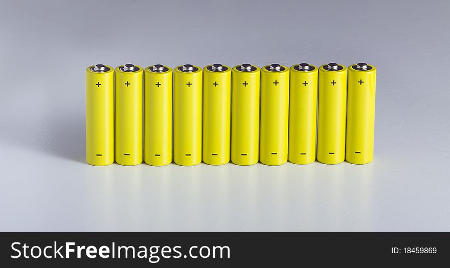 Lot of yellow battery in a row, with positive and negative sign. Lot of yellow battery in a row, with positive and negative sign