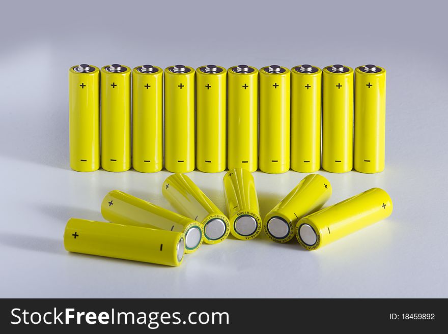 Lot of yellow battery in a row, with positive and negative sign. Lot of yellow battery in a row, with positive and negative sign