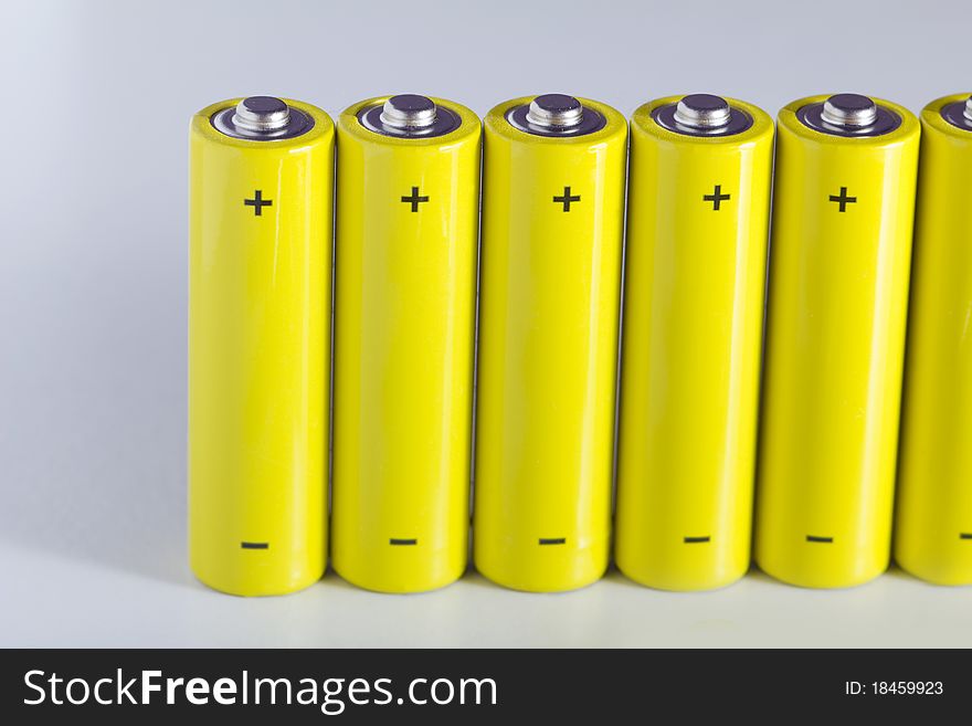 Lot of yellow battery in a row, with positive and negative sign. Lot of yellow battery in a row, with positive and negative sign