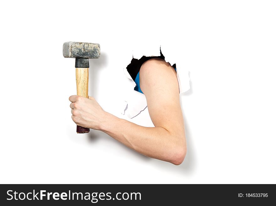 Close-up Hand With Hammer Through A Torn White Paper, Isolated. Hand Holding Hammer Close-up Sledgehammer Through Hole