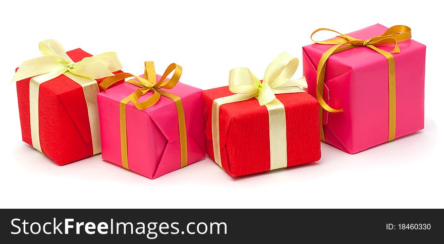 Red and pink gift boxes with satin ribbons isolated