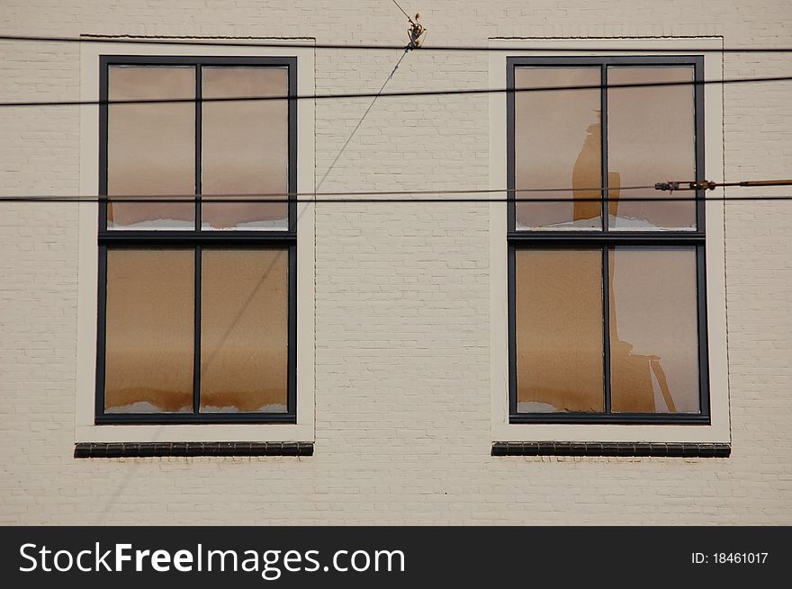 Two white windows with some cables