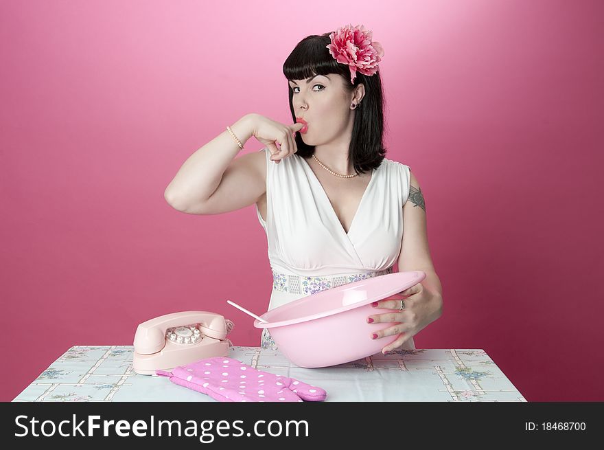 Gorgeous pinup model baking tasting food. Gorgeous pinup model baking tasting food