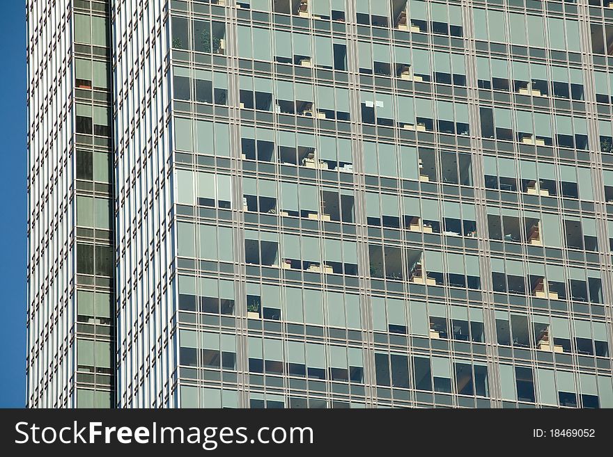 Looking up at a detail of a modern steel and glass office building. Window shades and furniture create an interesting pattern. Looking up at a detail of a modern steel and glass office building. Window shades and furniture create an interesting pattern.