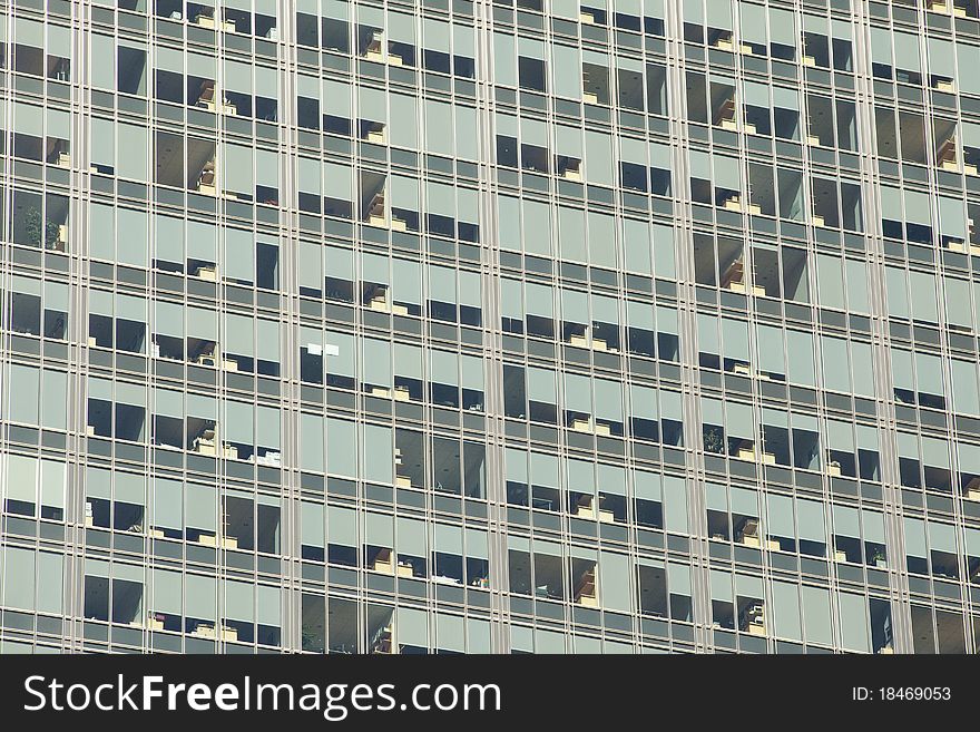 Looking up at a detail of a modern steel and glass office building. Window shades and furniture create an interesting pattern. Looking up at a detail of a modern steel and glass office building. Window shades and furniture create an interesting pattern.