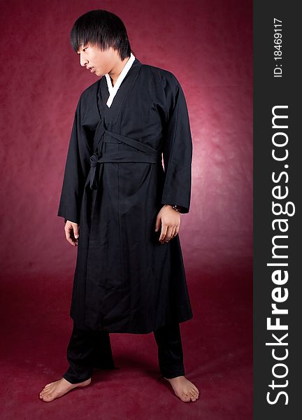 Korean man in a traditional dress on the red background.