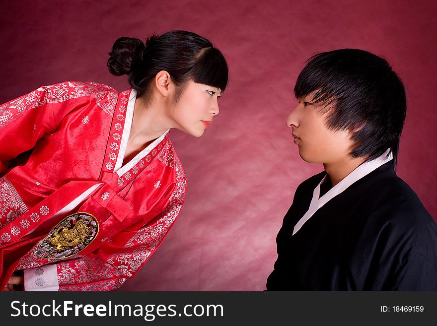 Asian traditional couple on the red background.