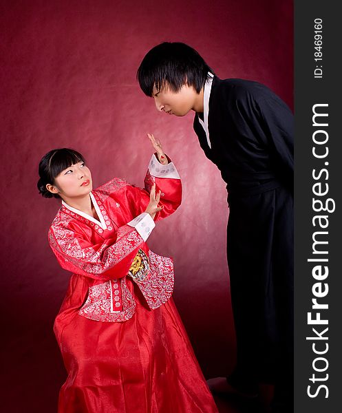 Asian traditional couple on the red background.