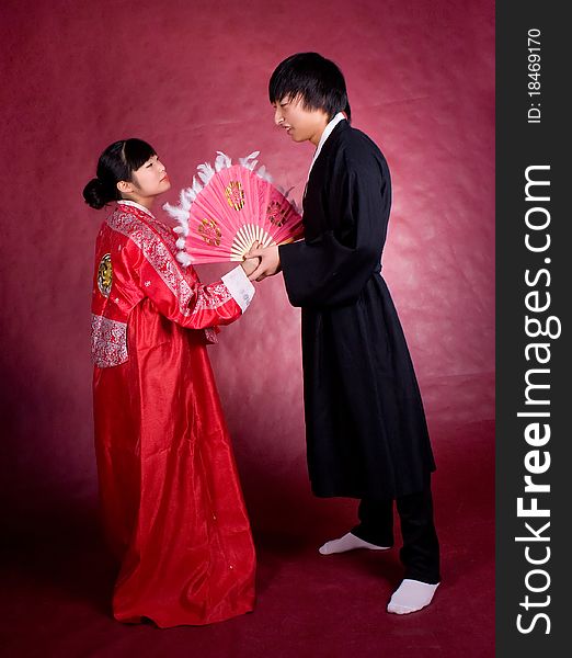 Asian traditional couple on the red background.