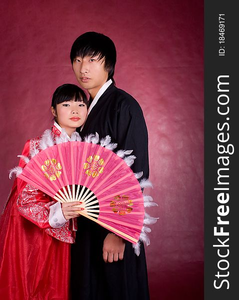 Asian traditional couple on the red background.