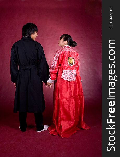 Asian traditional couple on the red background.