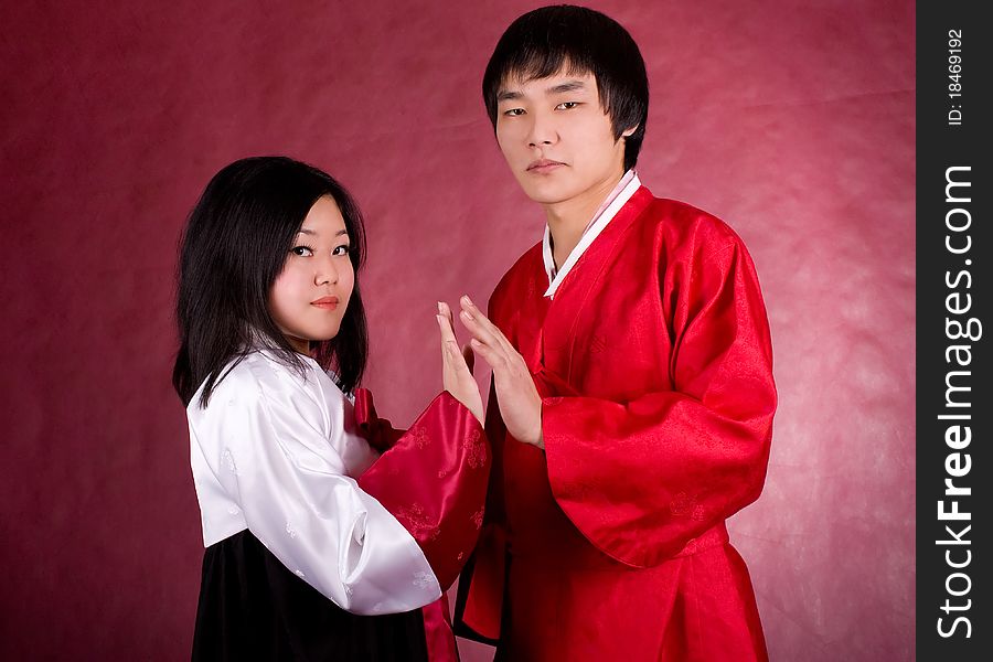 Asian traditional couple on the red background.