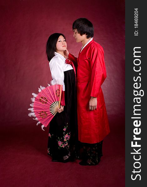 Asian traditional couple on the red background.