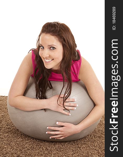 A woman is leaning on a large fitness ball. A woman is leaning on a large fitness ball.