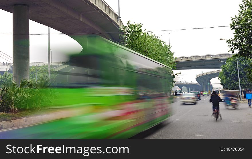 High-speed vehicles blurred trails on urban roads under overpass