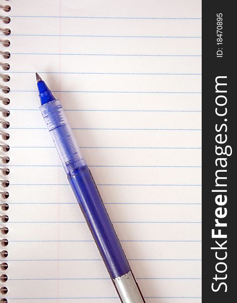 Spiral notepad and blue pen. Spiral notepad and blue pen