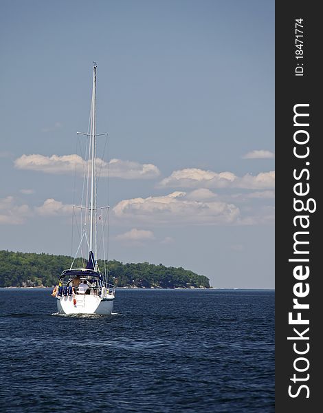 View of a sailboat off the western New York shore of Lake Champlain with the Adirondack Mountains in the background. Lake Champlain is a popular recreational spot for boaters, nestled between Vermont and New York, with Canada to the north. View of a sailboat off the western New York shore of Lake Champlain with the Adirondack Mountains in the background. Lake Champlain is a popular recreational spot for boaters, nestled between Vermont and New York, with Canada to the north.