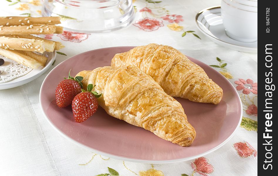 Croissants for breakfast with strawberry and cheese stick
