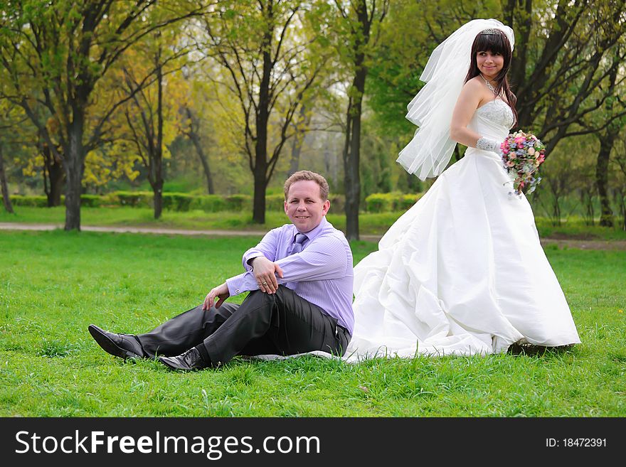 Happy groom and the bride on walk