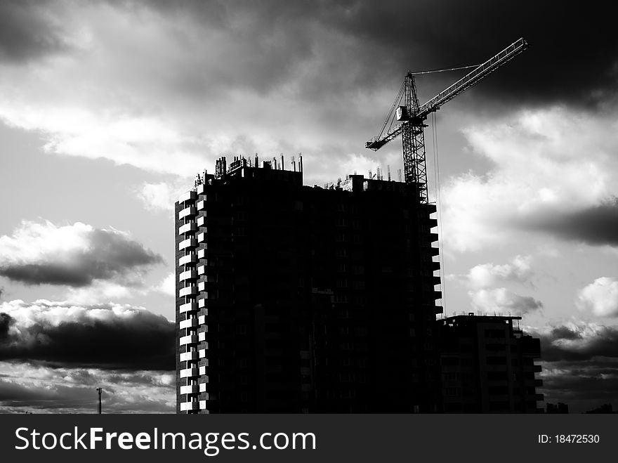 Frontal view house under construction and crane