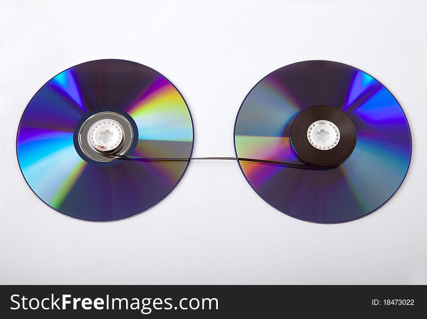 Two discs with a cassette tape between them. Two discs with a cassette tape between them