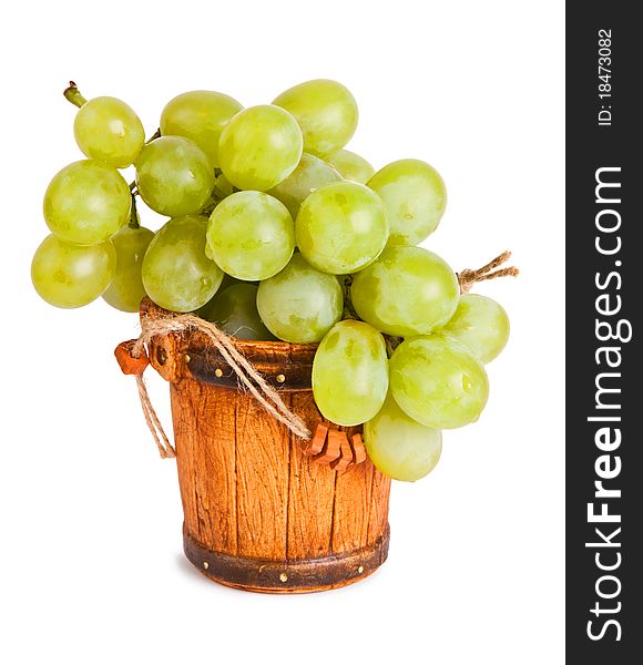 Cluster of green ripe grapes in a small souvenir bucket. Cluster of green ripe grapes in a small souvenir bucket