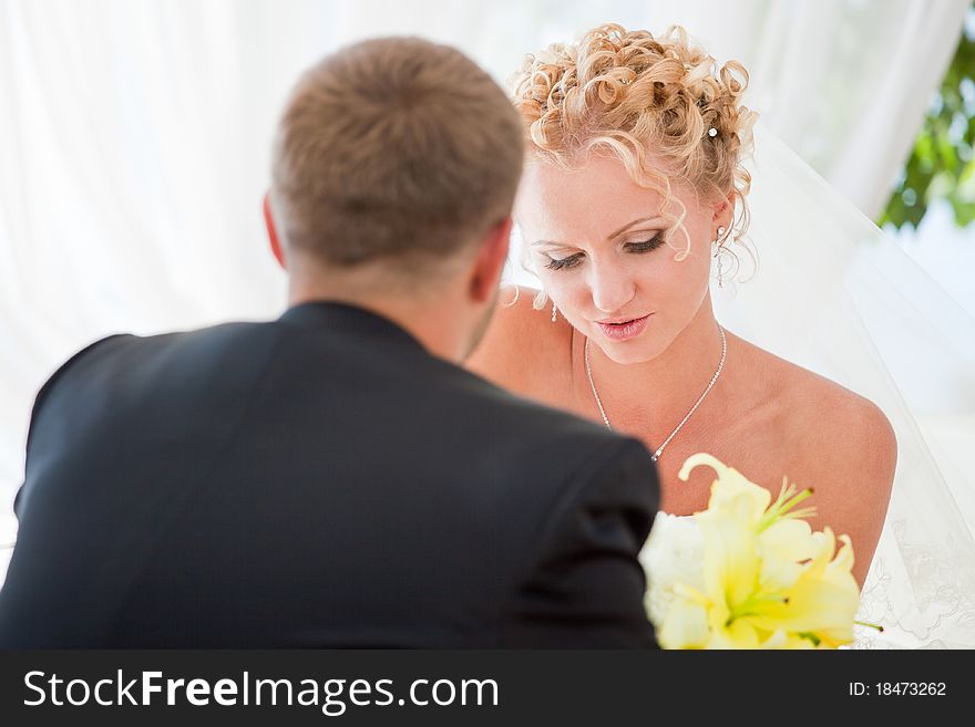 Bride and groom drinking coffee at an outdoor cafe